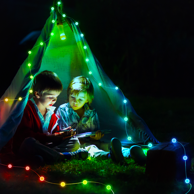 Jcfyoo RGB star string lights glowing in multicolor on outdoor balcony railing at night with city skyline in background
