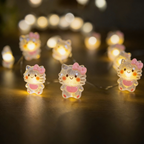 Close-up of sleepy kitten LED decorations on flexible copper wire