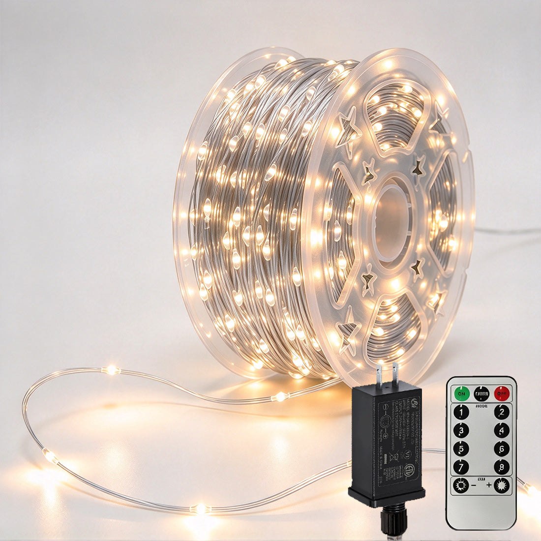 Silver-wire copper fairy lights on a reel with warm-white LEDs, power adapter and remote