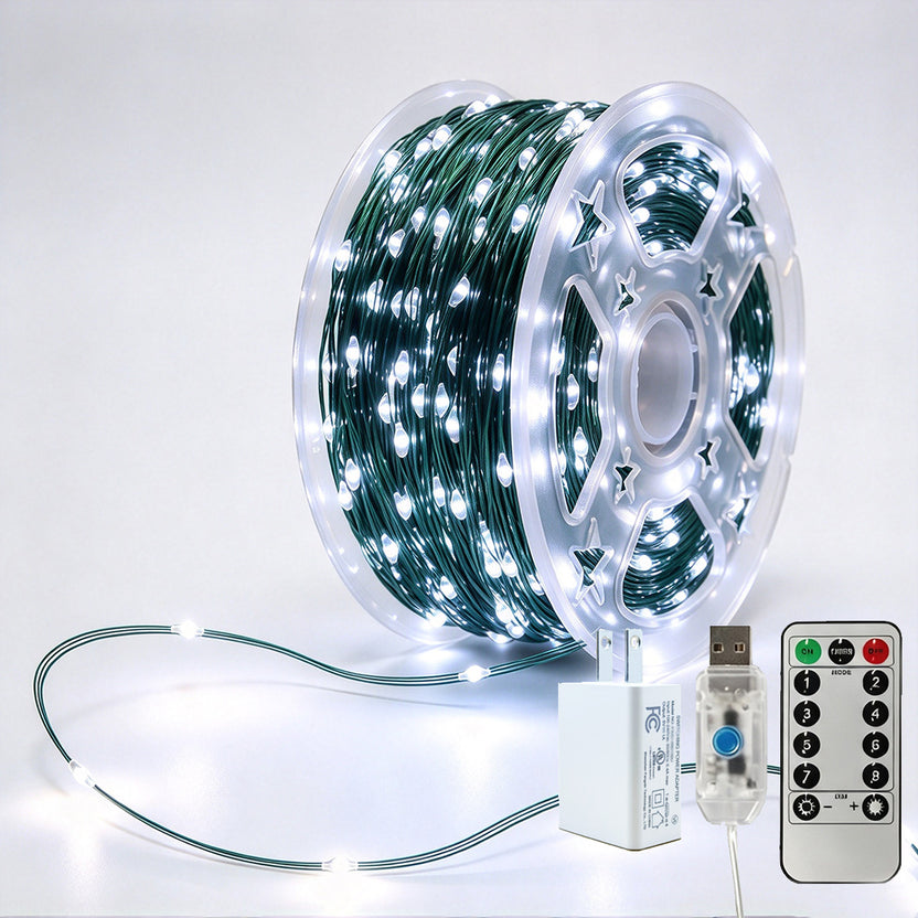 Green-wire copper fairy lights on a reel with crisp-white LEDs, USB controller, remote and power adapter