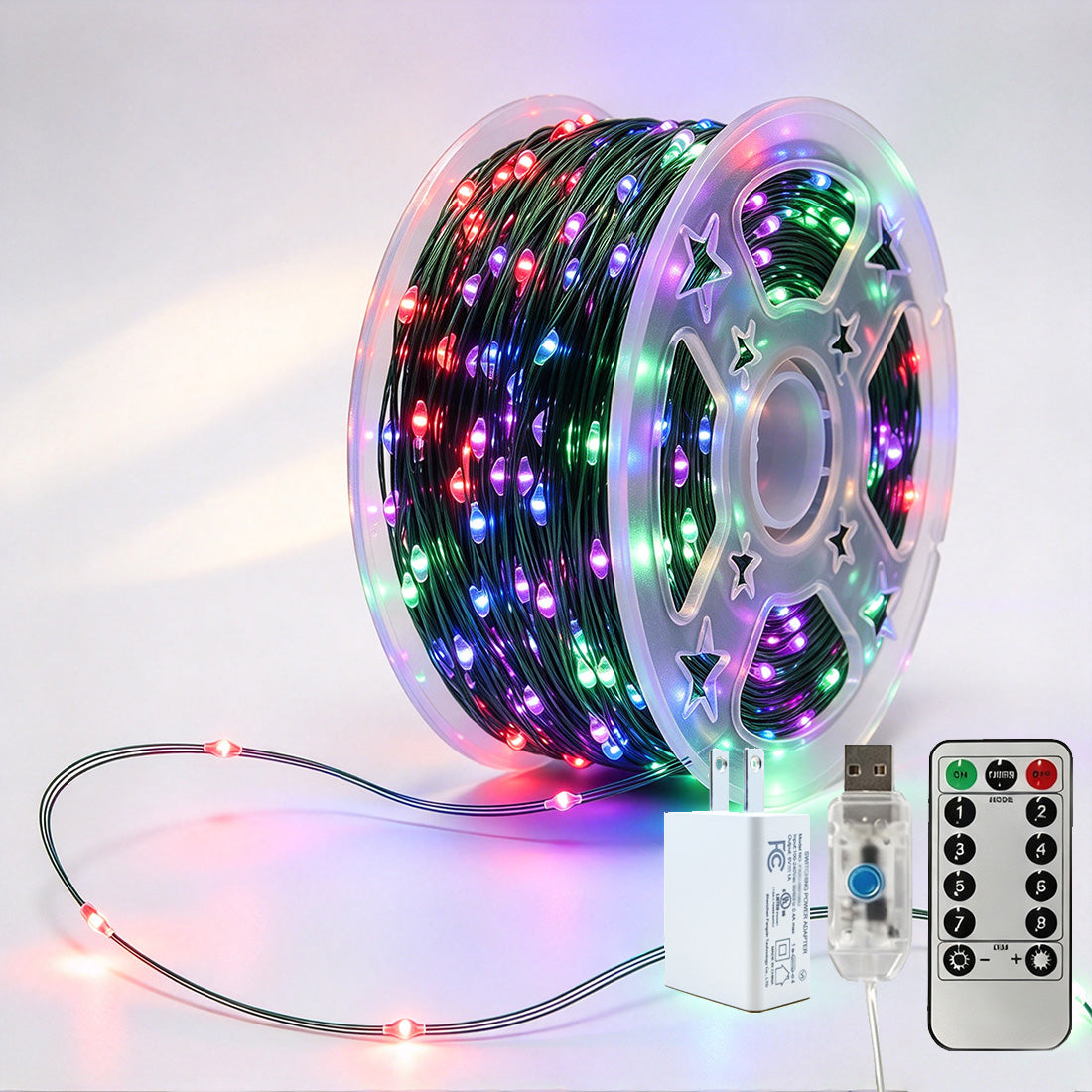 Green-wire copper fairy lights on a reel with multicolor LEDs, USB controller, remote and power adapter
