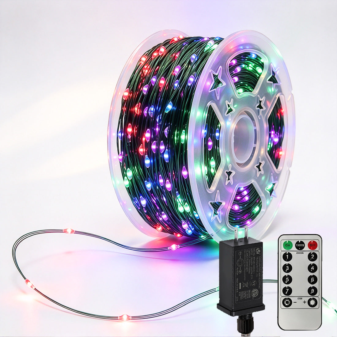 Green-wire copper fairy lights on a reel with multicolor LEDs, power adapter and remote