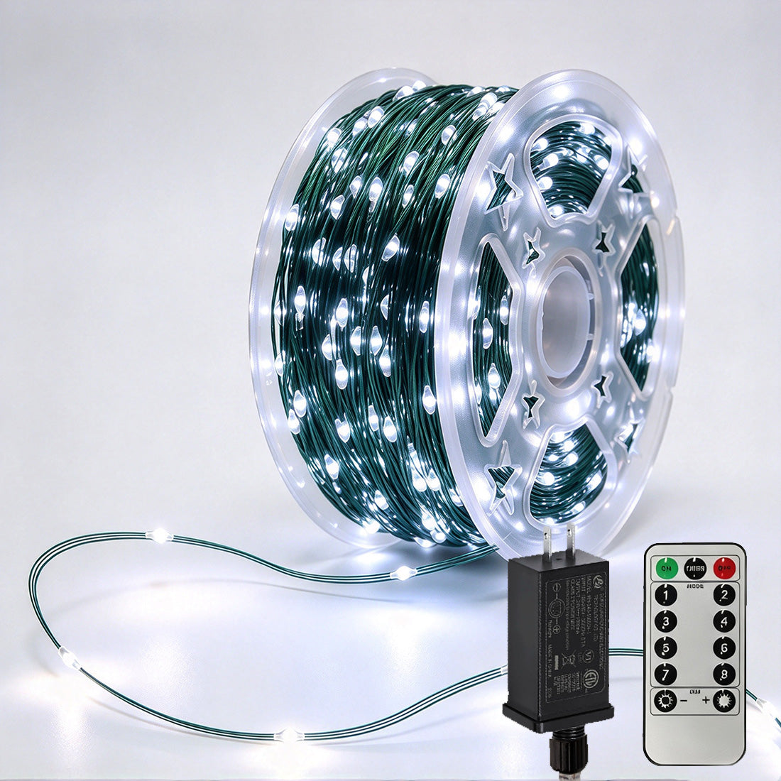 Green-wire copper fairy lights on a reel with crisp-white LEDs, power adapter and remote