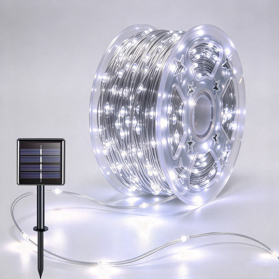 Silver-wire copper fairy lights on a reel with crisp-white LEDs and a solar panel