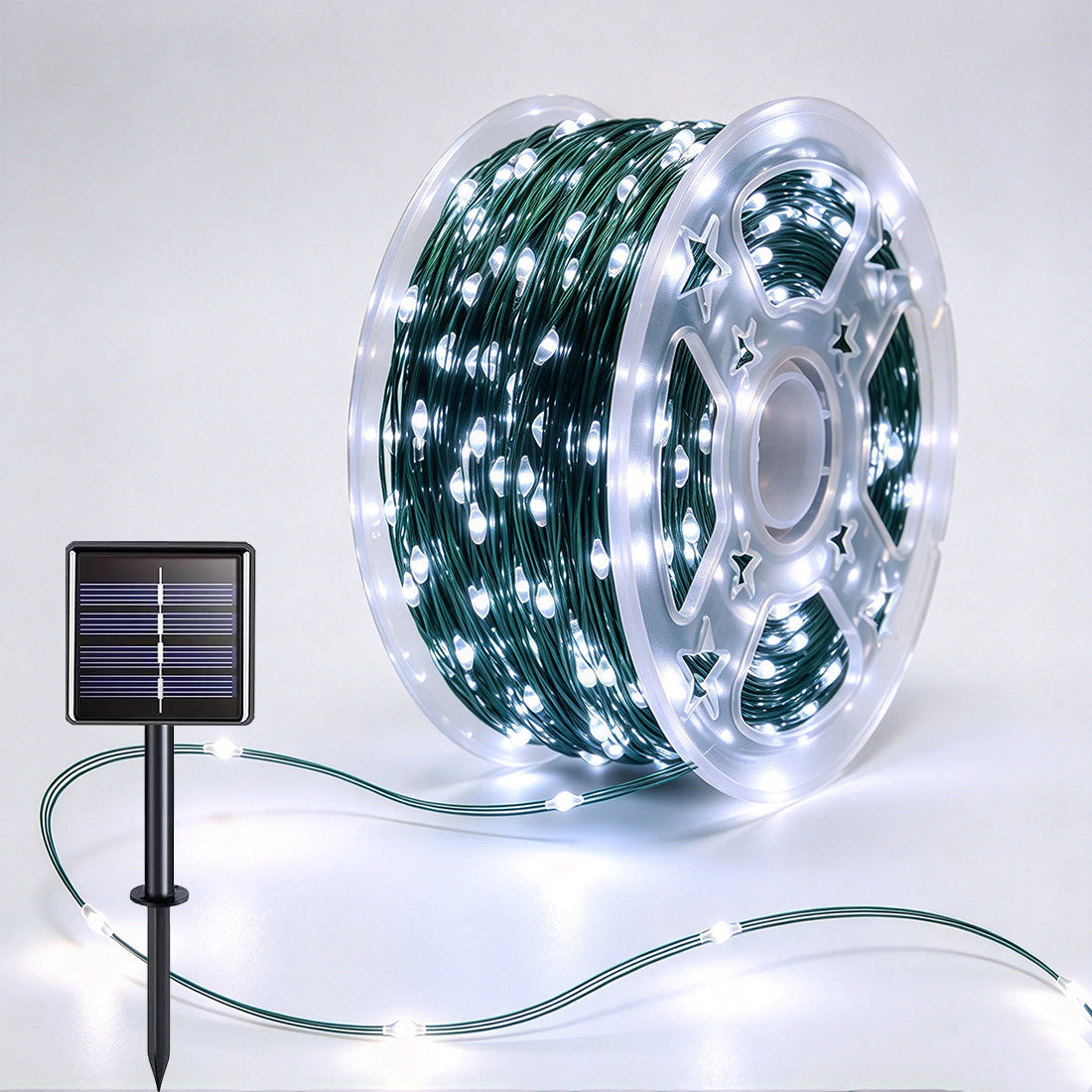 Green-wire copper fairy lights on a reel with crisp-white LEDs and a solar panel